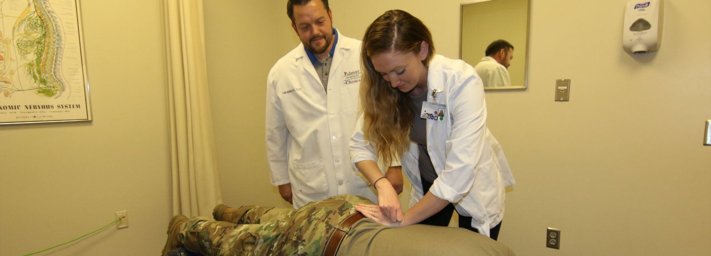 Chiropractor and student intern performing an adjustment