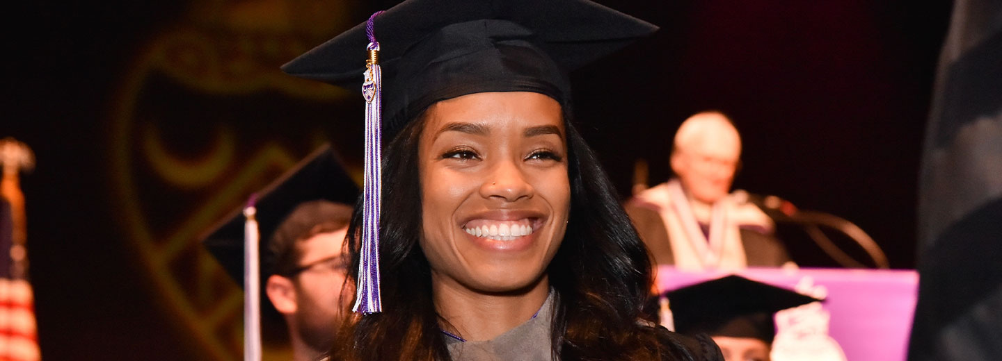 student smiling in graduation cap
