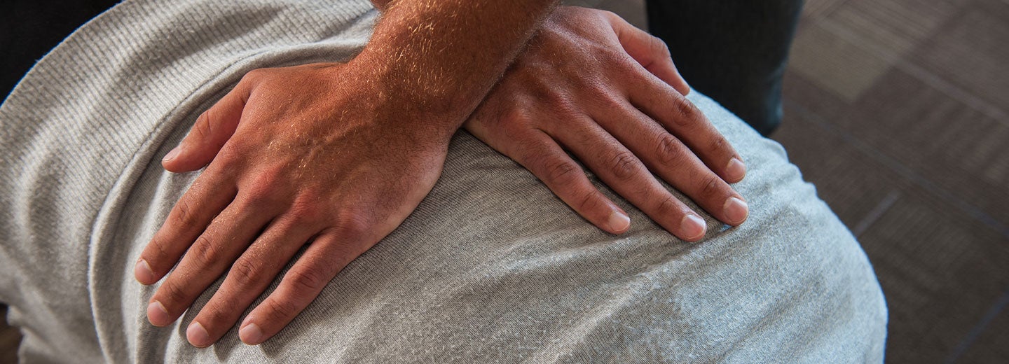 hands criss-crossed on a patient's back