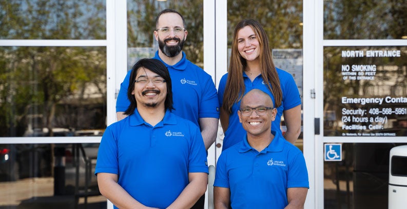 Photo of four Palmer Business Ambassadors standing outside at Palmer West.