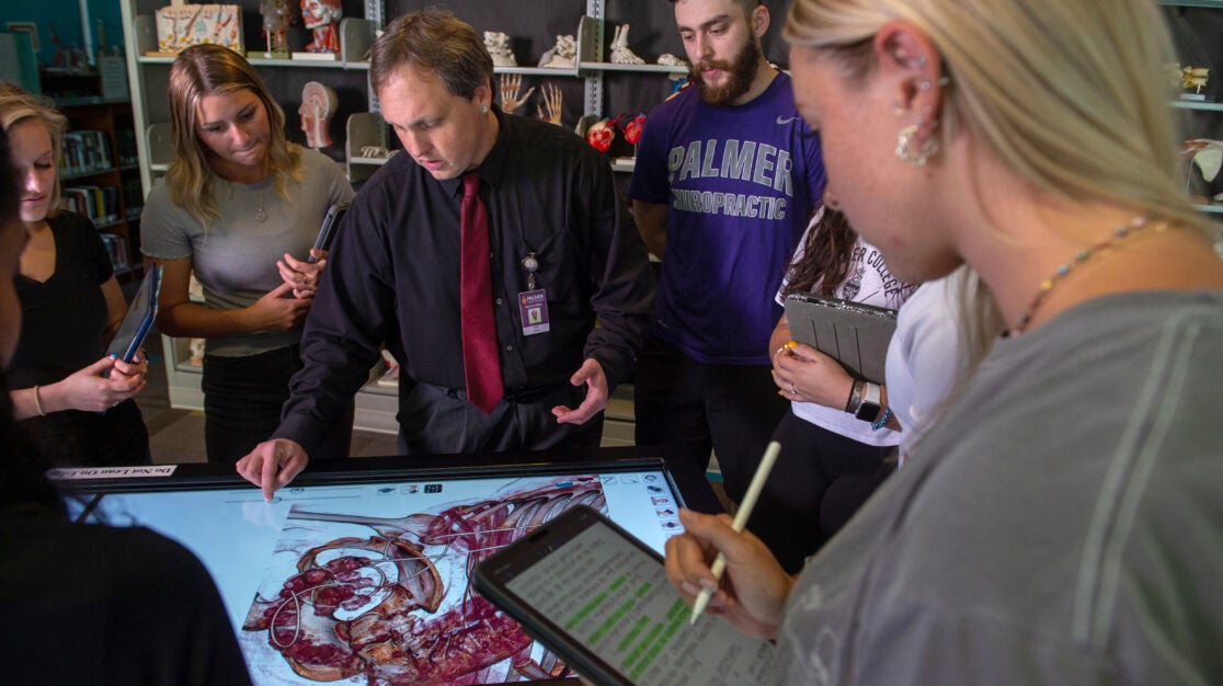 Students standing around Anatomage table