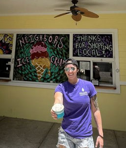 young person in Palmer shirt holding ice cream.