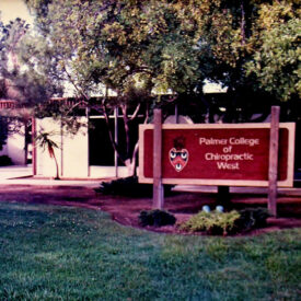 Palmer West sign in front of building in 1980s.