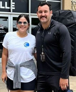 Dr. Mena and Dr. Gonzalez smiling outside CrossFit festival.