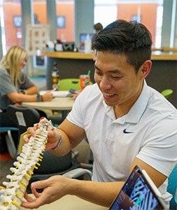 Wooseok Choi holding spine model