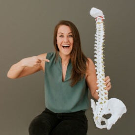 Dr. Megan Zaner holding spine model.