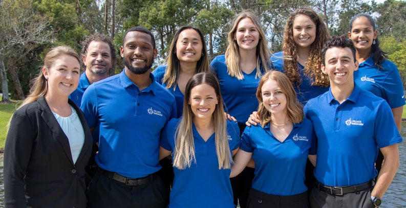 Group of students in blue ambassador polo shirts.