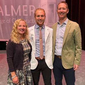 student Matt Eckard smiling with two other people.