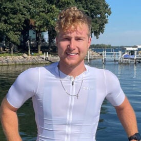 Matt Eckard smiling outdoors in front of waterway.