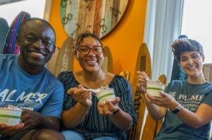 Three Palmer students smiling with bowls of ice cream.