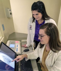 Two radiology students examining X-ray. 