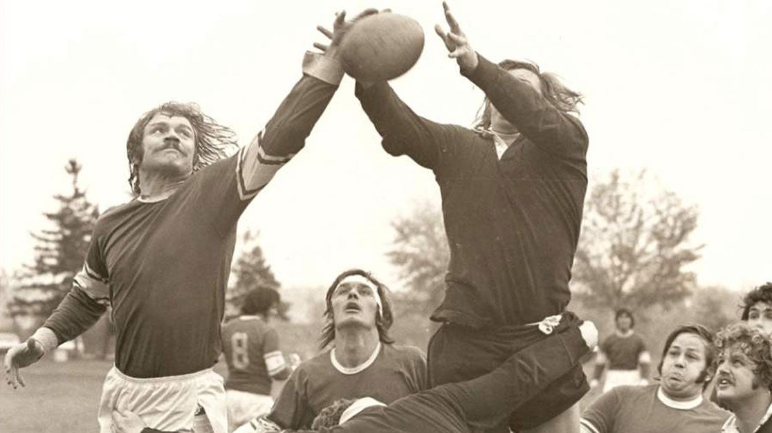 Black and white historical photo of Palmer rugby players outdoors.