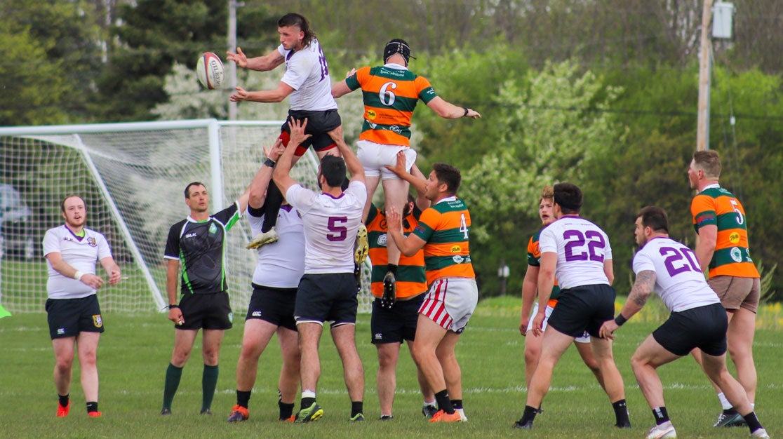 Men's rugby teams playing outdoors.