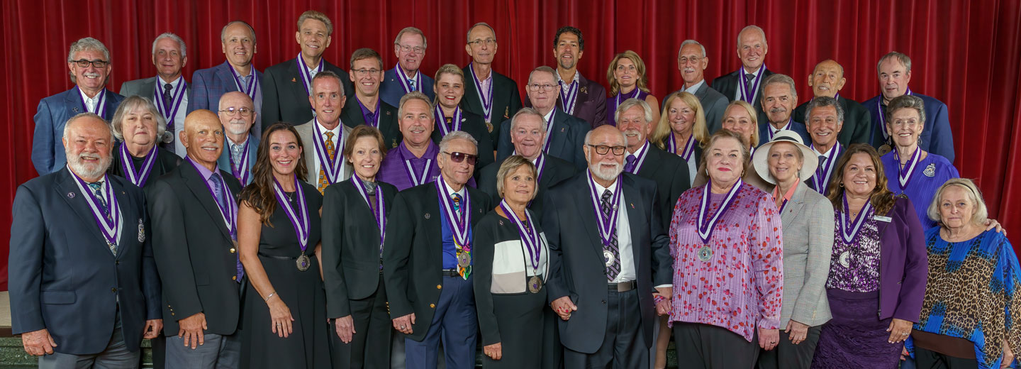 Large group of Fellows wearing medallions on purple ribbon.