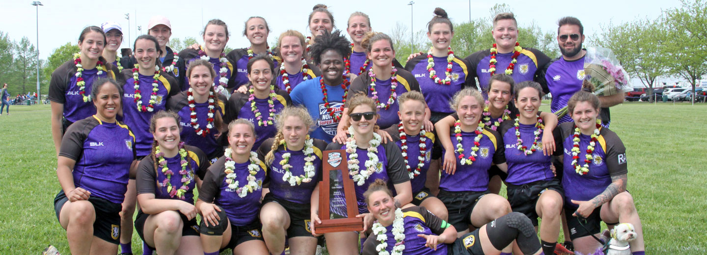 Outdoor group photo of Palmer women's rugby team with trophy.