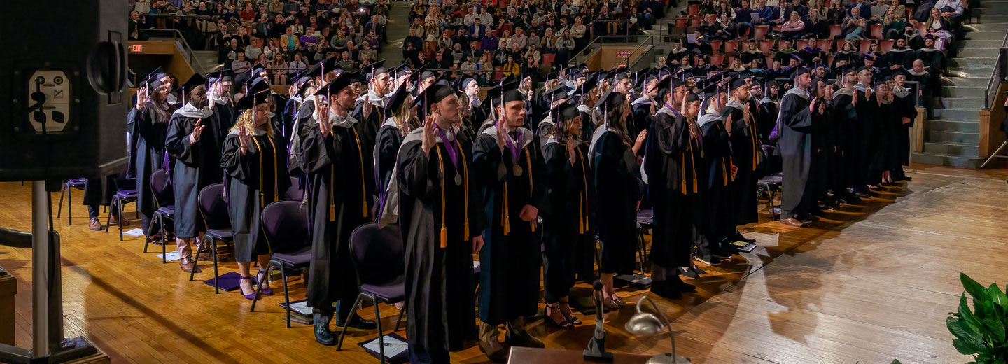 Large group of students wearing robes and graduation caps.