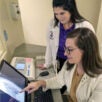 Two radiology students examining X-ray.