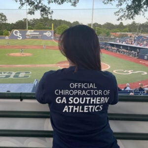 FlorAnne Cruz, D.C. standing in front of a baseball diamond.