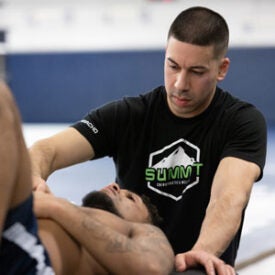 Dr. Camacho working with client lying on mat.