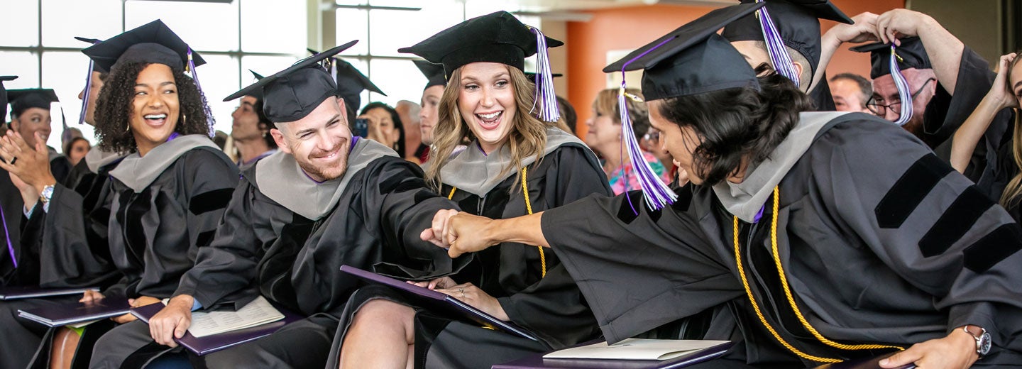 Group of Florida students in graduation robes.