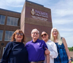 Dr. Kiernan in purple polo with Kiernan Hall in background. 