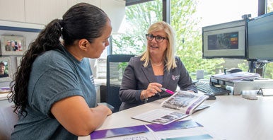 Admissions counselor talking to incoming student.
