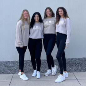 Four Palmer College students in black leggings and Palmer sweatshirts.