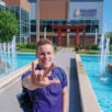 Student Jake Koerner in the Clinic Gardens signing with hands.