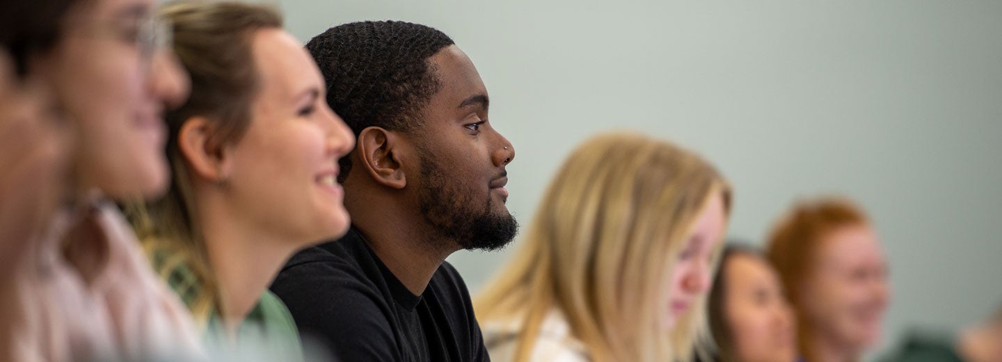 Students sitting side by side in lecture.