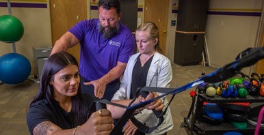 Clinician and intern working with rehab client.