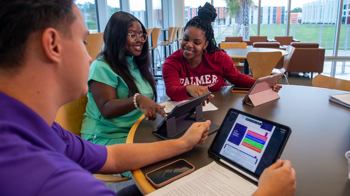 Students studying together on tablets.