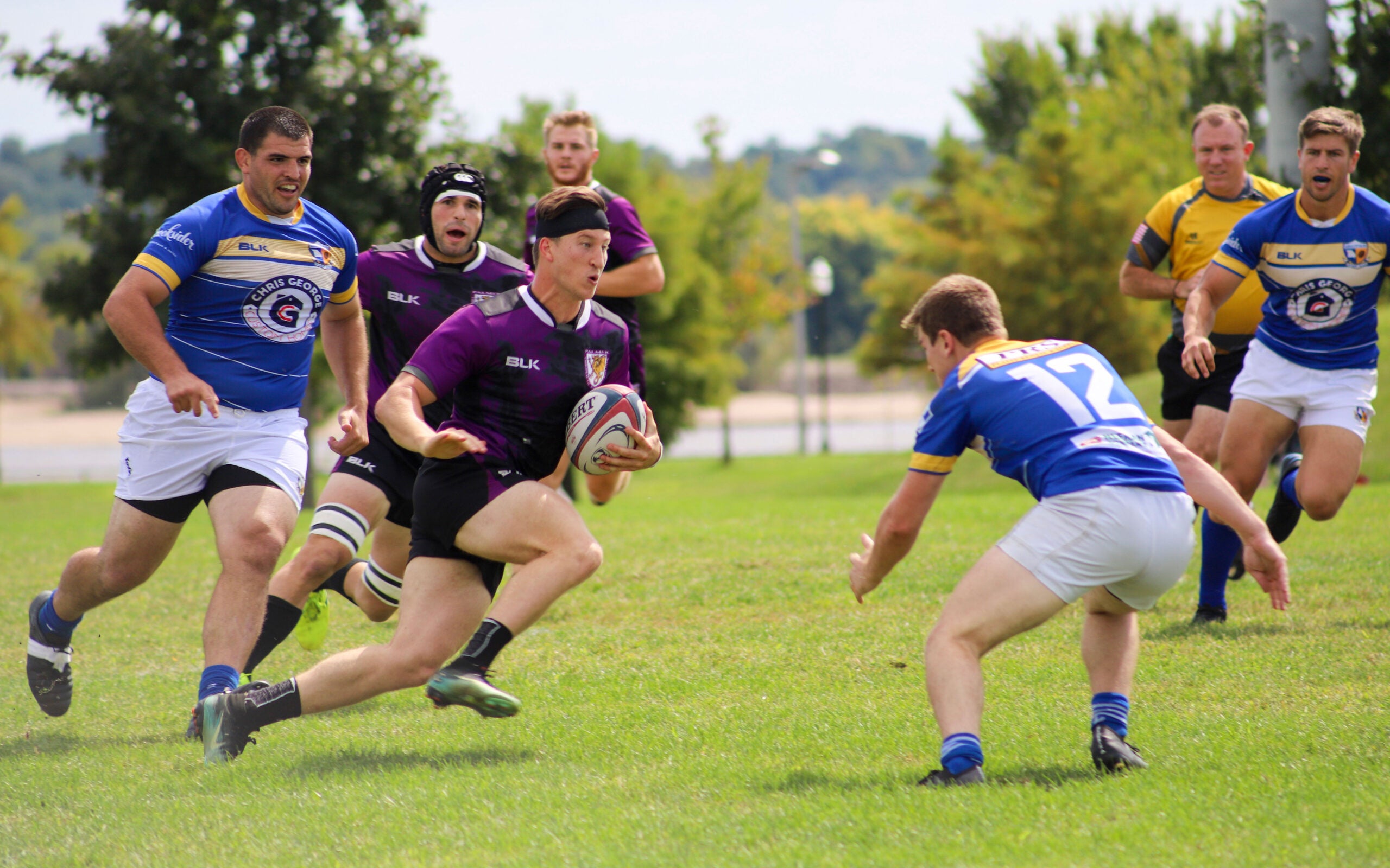 Men's rugby team playing.