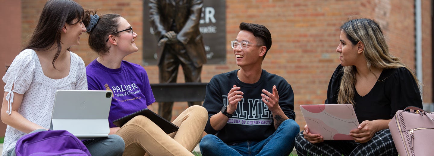 Students talking in front of First Adjustment Stateu.