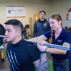 Student Elise Bealer overseeing client in Sports and Rehab center.