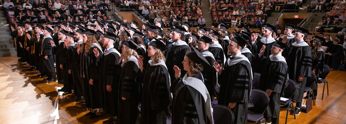 Students wearing caps and gowns at graduation.