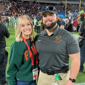 Student Vinny Williams and wife standing in outdoor field.