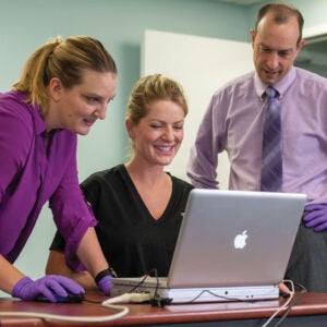 Researchers gather to review computer data.