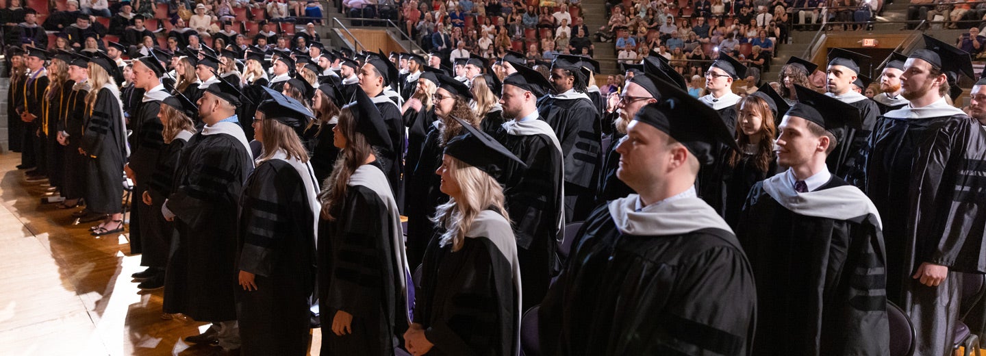 Main graduating class 242 in caps and gowns.