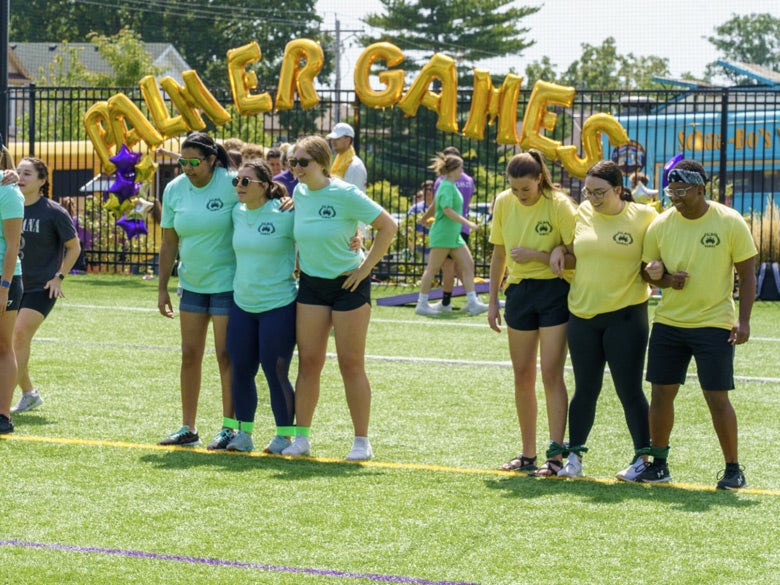 Teams ready to participate in three-legged race outdoors during Palmer Games.