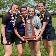 Allison David and members of the Rugby team holding trophy.