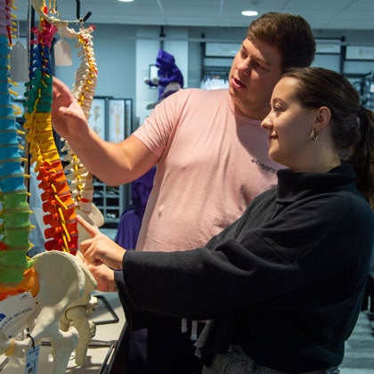 Students considering spine model in the Campus Store.