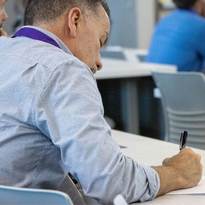Homecoming attendee taking notes.