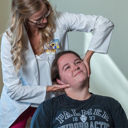 Dr. Clark adjusting patient's neck.