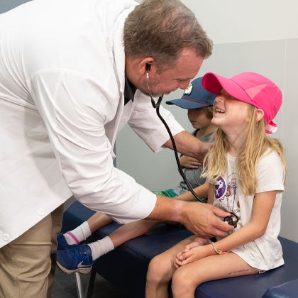 Clinician with pediatric patients.