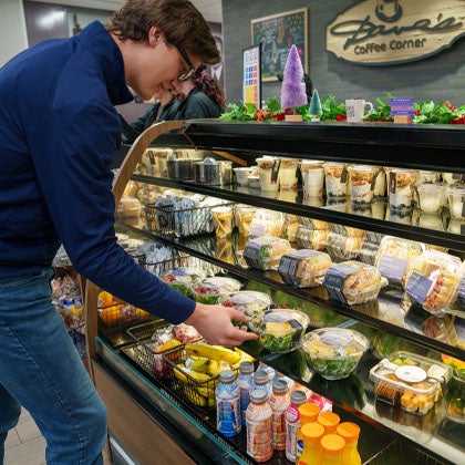 Student grabbing salad from Dave's Coffee Corner.