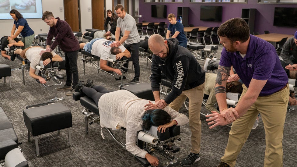 Instructor and students in the Experiential Learning Center.