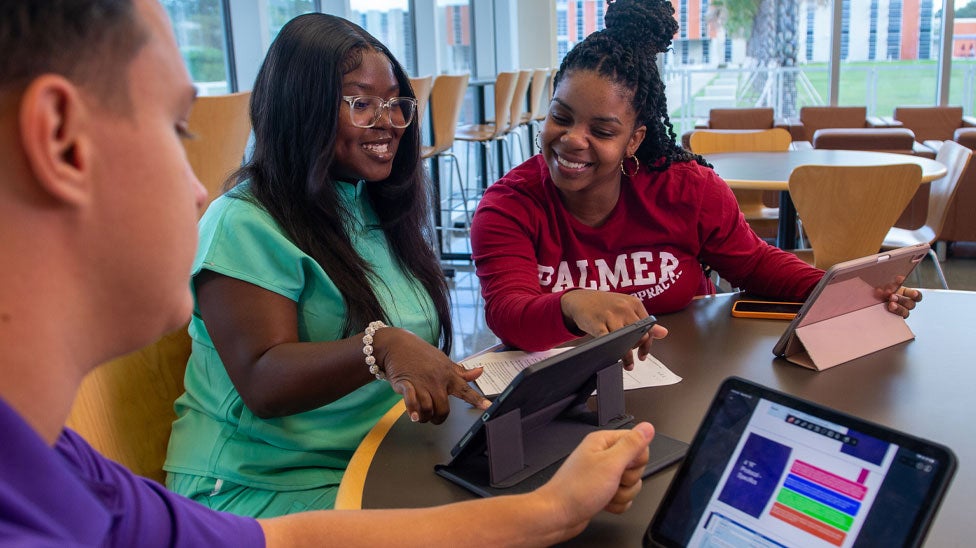 Students studying on tablets in the cafeteria on Palmer Florida.