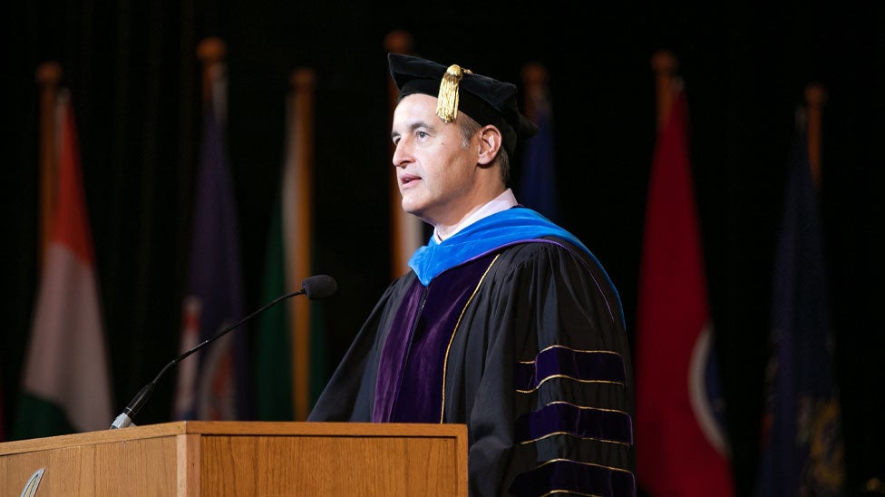 Dr. Marchiori speaking at graduation.