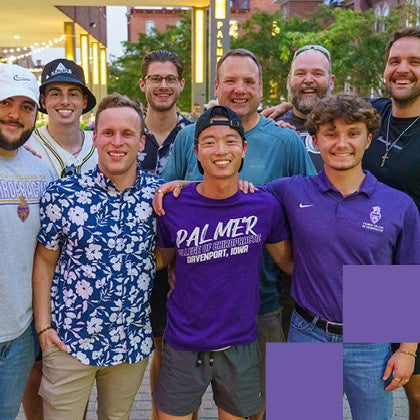 A group of students and alumni at the Homecoming courtyard party.