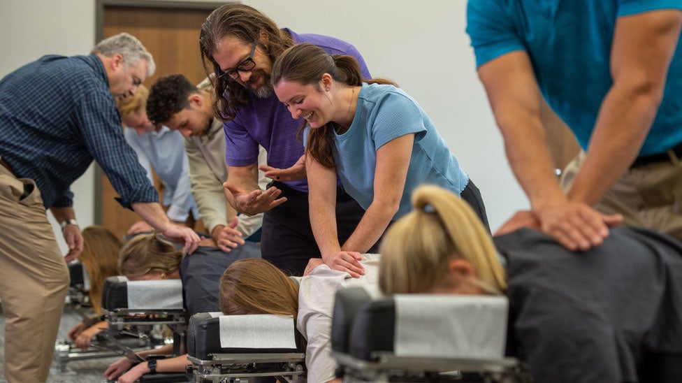 Instructors observing students in the technique lab.